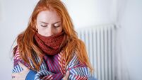 One person feeling cold at home having heating problem