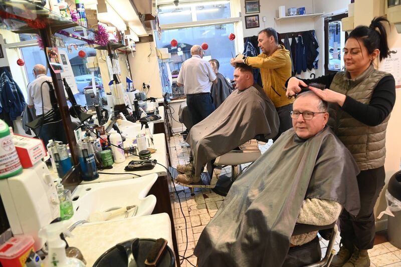 Staff member Amy O'Donovan with customer Martin Dorgan in the chair at the premises. Pic Larry Cummins