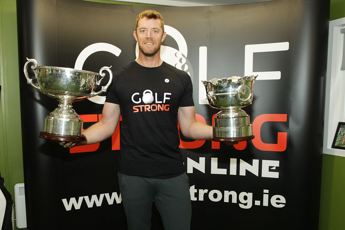 Peter O'Keeffe back at work in his gym on Monday with the Irish Amateur Close and Irish Amateur Open cups. Picture: Niall O'Shea