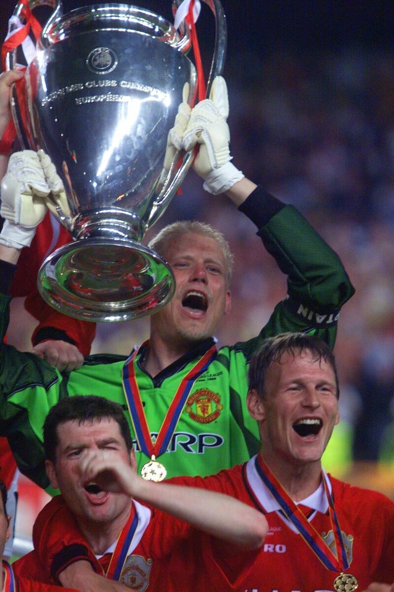 Manchester United captain Peter Schmeichel holds aloft the trophy flanked by Teddy Sheringham, right, and Denis Irwin. Picture: AP Photo/Camay Sungu Manchester United captain Peter Schmeichel holds aloft the trophy flanked by Teddy Sheringham, right, and Denis Irwin. Picture: AP Photo/Camay Sungu