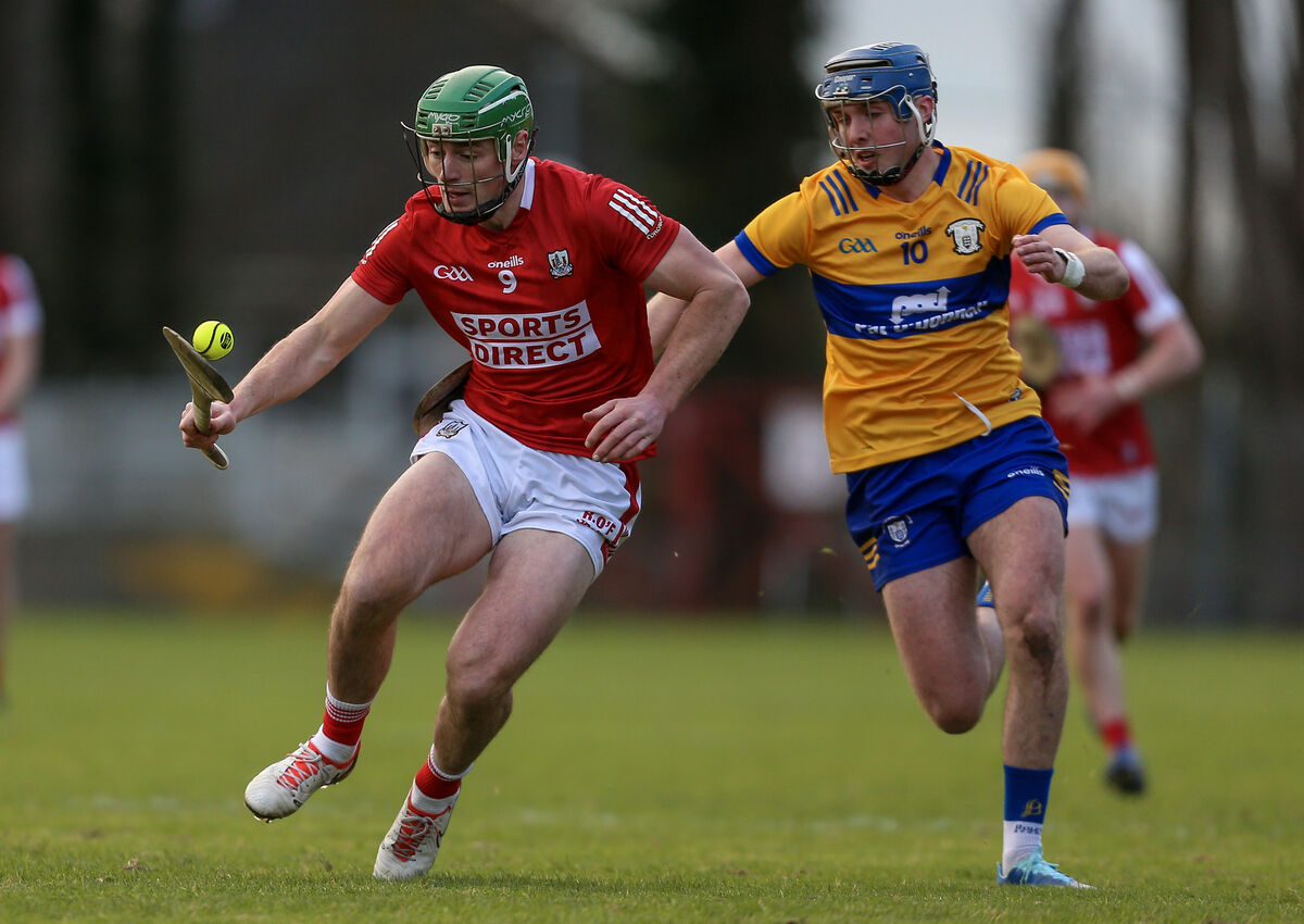 Cork’s Robbie O’Flynn holds possession as Clare’s Keelan Hartigan shadows him. Picture: Inpho/Ken Sutton