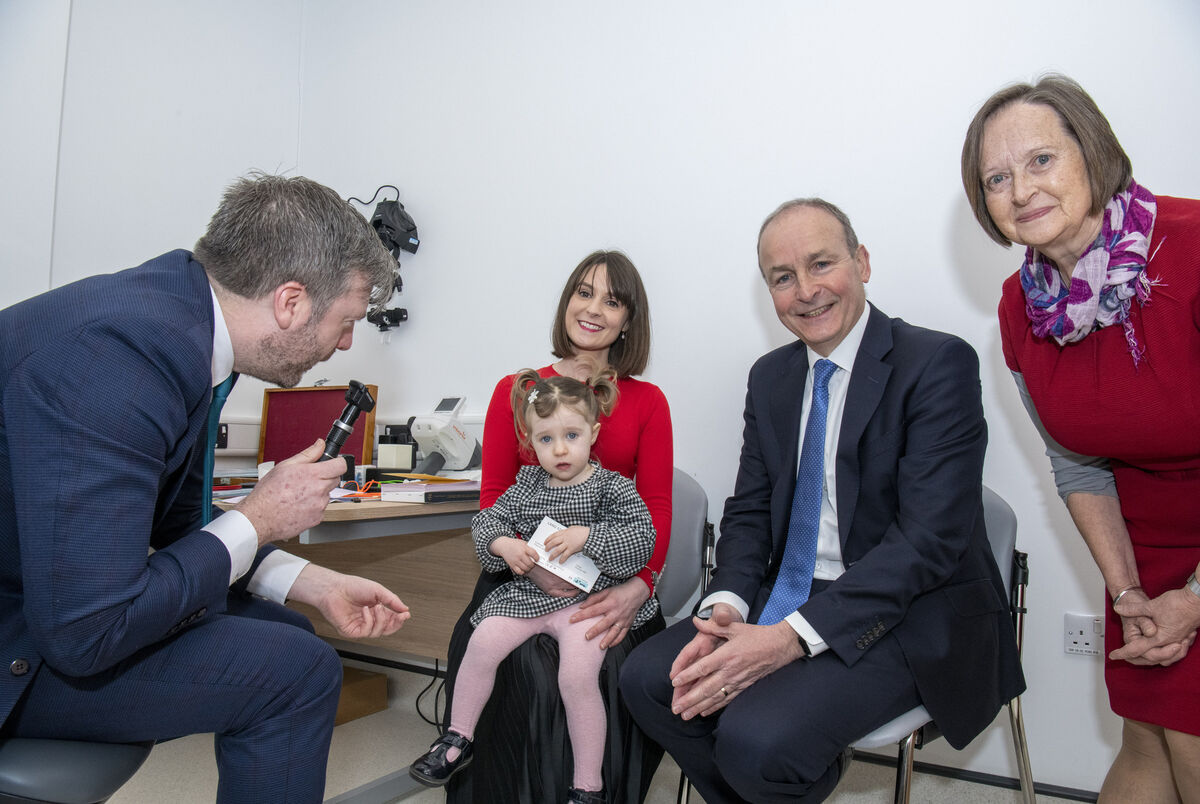 Pictured having an eye test is two-year-old Elise Morgan by her dad Michael and mum Georgina Ring who are both optometrists. Also included is Beatrix Haskins. Pic: Brian Lougheed