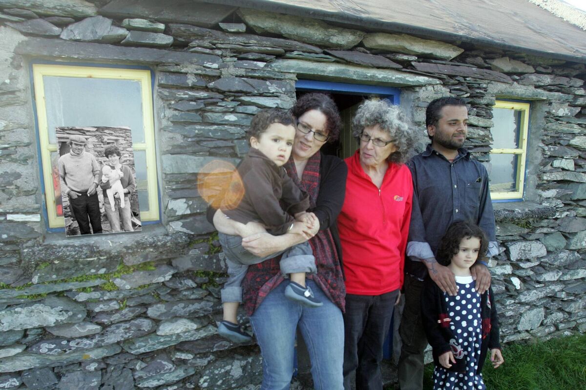 Neillí Ní Cathain - the baby in the main photo - with her mother, Eibhlín, and her husband and children outside their cottage on the Great Blasket Island - the 1976 photo is in the window. Neillí Ní Cathain - the baby in the main photo - with her mother, Eibhlín, and her husband and children outside their cottage on the Great Blasket Island - the 1976 photo is in the window.
