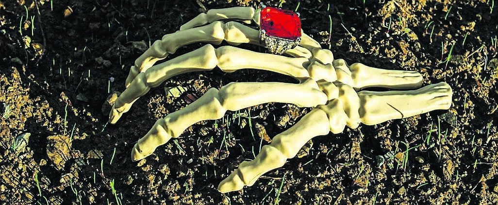A mocked-up photo of a skeleton trying to escape a grave, by Tim Cagney