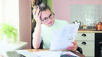 Indoor shot of young European Caucasian girl looking at financia