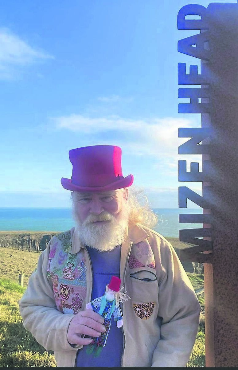 Owen Kelly holding Seamus the doll at Mizen Head.