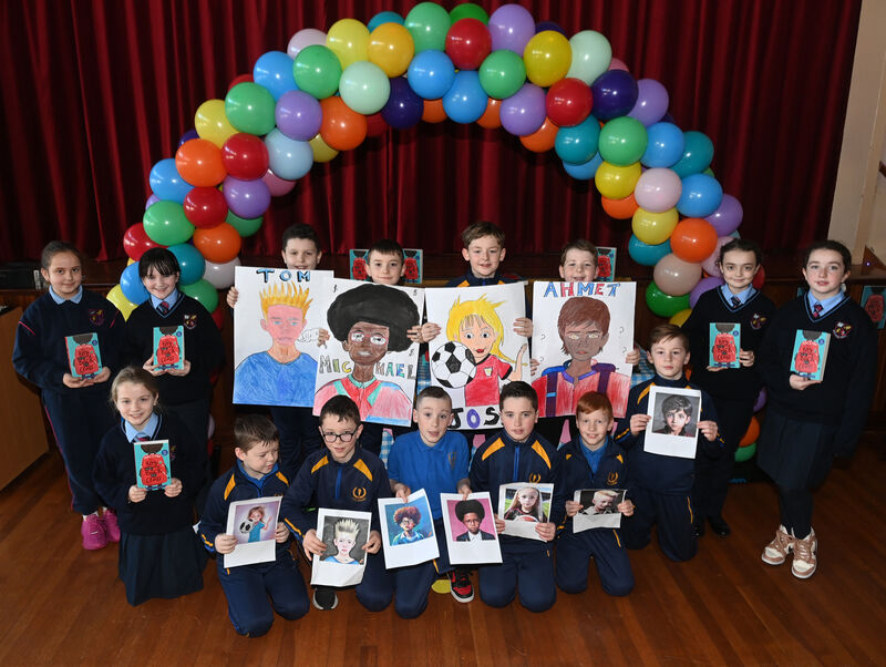 Pupils from Scoil Aiséirí Chríost and Scoil Íosagáin with artwork created based on the book characters at the launch of the One Book One Community project with the book 'The Boy at the Back of the Class'. Pic Larry Cummins Pupils from Scoil Aiséirí Chríost and Scoil Íosagáin with artwork created based on the book characters at the launch of the One Book One Community project with the book 'The Boy at the Back of the Class'. Pic Larry Cummins