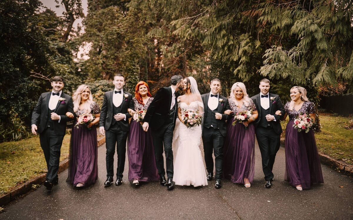 The couple with their wedding party. The couple with their wedding party.