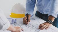 engineer meeting for an architectural project. working with partner and engineering tools working on blueprint architectural pro