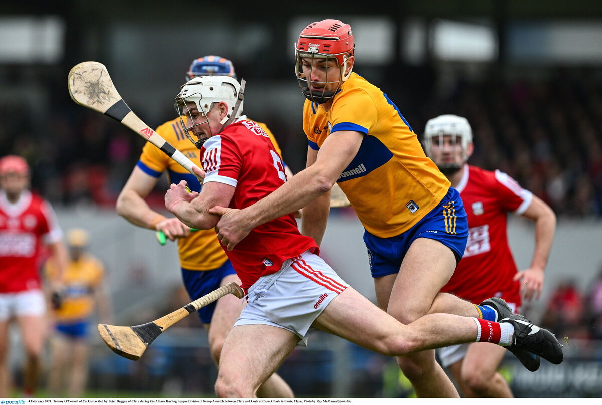 Tommy O'Connell of Cork is tackled by Peter Duggan of Clare. Picture: Ray McManus/Sportsfile