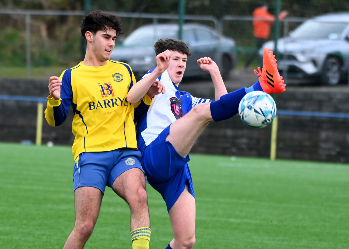 College Corinthians Jimmy Harte wins the ball from Douglas Hall's Louka Mohan during the Jako Munster Youths cup at Moneygourney. Picture; Eddie O'Hare