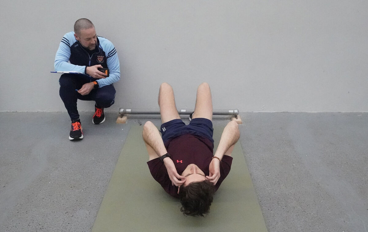 Instructor sergeant Patrick Kirwan times a journalist taking part in a fitness test during a recruitment campaign launch at the Garda training centre in Templemore, co Tipperary. Picture: Niall Carson/PA Wire