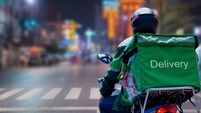 At Street Food in night city, Thailand, delivery drivers are making deliveries to consumers who have placed online orders