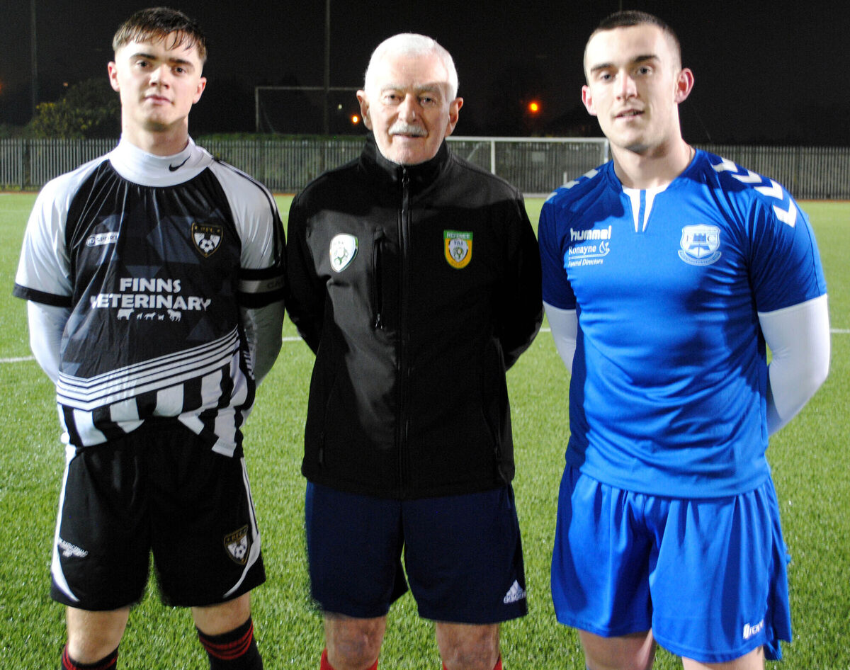 Rathcormac captain Richard Morrisson (left) with Castlebridge Celtic's Keith Condon, accompanied by referee Billy Noonan.