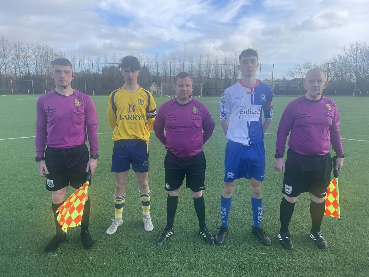 Assistant referee Dennis O’Rourke, Douglas Hall captain Ben Heas, referee Anthony Morrison, Stella Maris captain Josh Benton and assistant referee Thomas Sheehy before the U18 FAI Cup at Moneygourney.