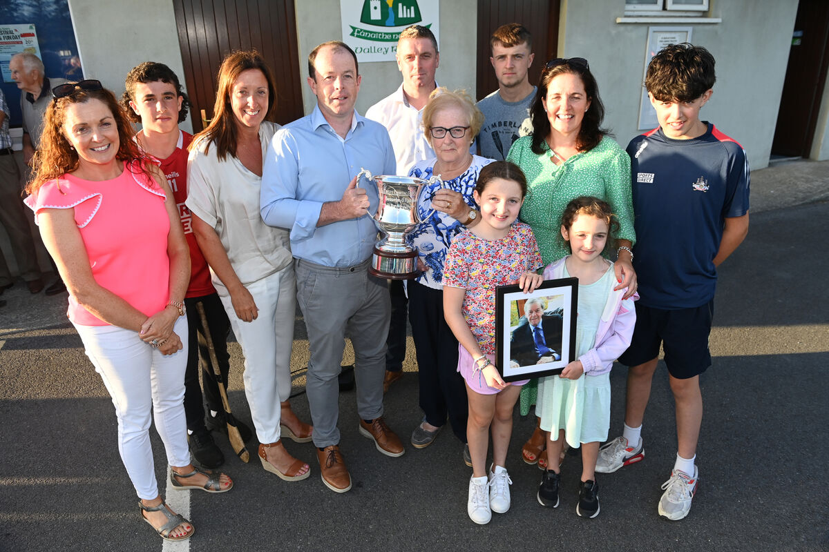Mary O'Riordan, wife of the late Denis O'Riordan of Valley Rovers, presenting the cup in his memory - awarded to the winners of the Premier SHC Divisions/Colleges section - to Marc Sheehan, Cork County Board chairperson, in 2002. Included are his son Ciarán, daughters Trish, Maria, and Caroline and grandchildren Eoghan, Donncha Galgey, Harry Donegan, Doireann and Siún Rochford Picture: Eddie O'Hare