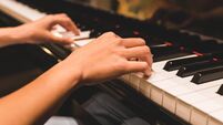 Asian woman hand playing keyboard of a piano in romantic atmosphere. Music instrument, solo pianist, song composer, hobby, pract