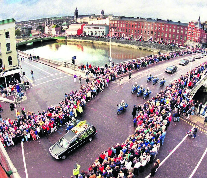 The funeral cortege with the remains of one of Cork's famous sons the late Jack Lynch passing over St. Patrick's Bridge onto to St. Patrick Street as crowds line the route in Cork city centre with Shandon and the North Cathedral dominating the skyline. Picture Denis Minihane.