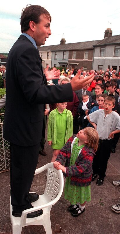 Seven year old Victoria Lester listening attentively to the then new Minister for Education Micheal Martin as he addressed the large gathering of relations, neighbours and friends who paraded along South Douglas Road and O'Connell Avenue with him to welcome him back to Cork. Picture Denis Minihane.