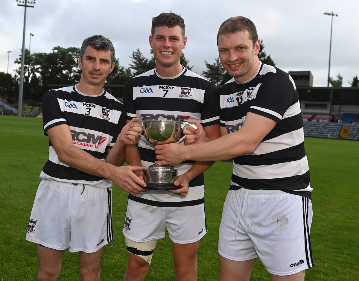 St. Oliver Plunkett's joint hurling captains, Eddie O'Driscoll and Conor McCarthy, with football captain Ronan McCarthy (centre) after completing the Junior B championship double with a hurling final win over Ballyclough at Pairc Ui Rinn.
