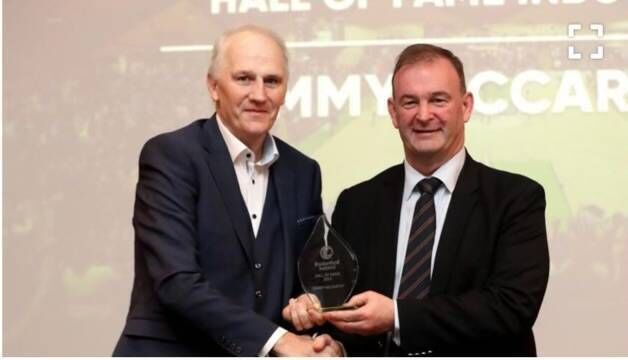 Tim McCarthy receives his Hall Of Fame award from Basketball Ireland CEO John Feehan