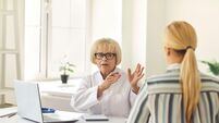 Senior female doctor tells and explains to the patient his diagnosis during the consultation.