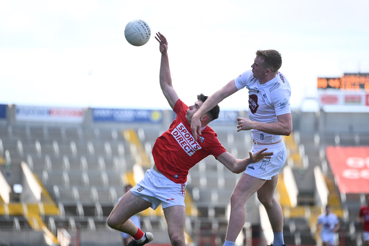  Ed Meyers gets a hand to the ball ahead of half-back Mark Fitzsimons. Picture: Larry Cummins