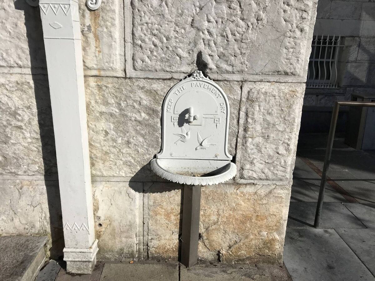 A drinking fountain on the front wall of the Cork Courthouse on Washington Street