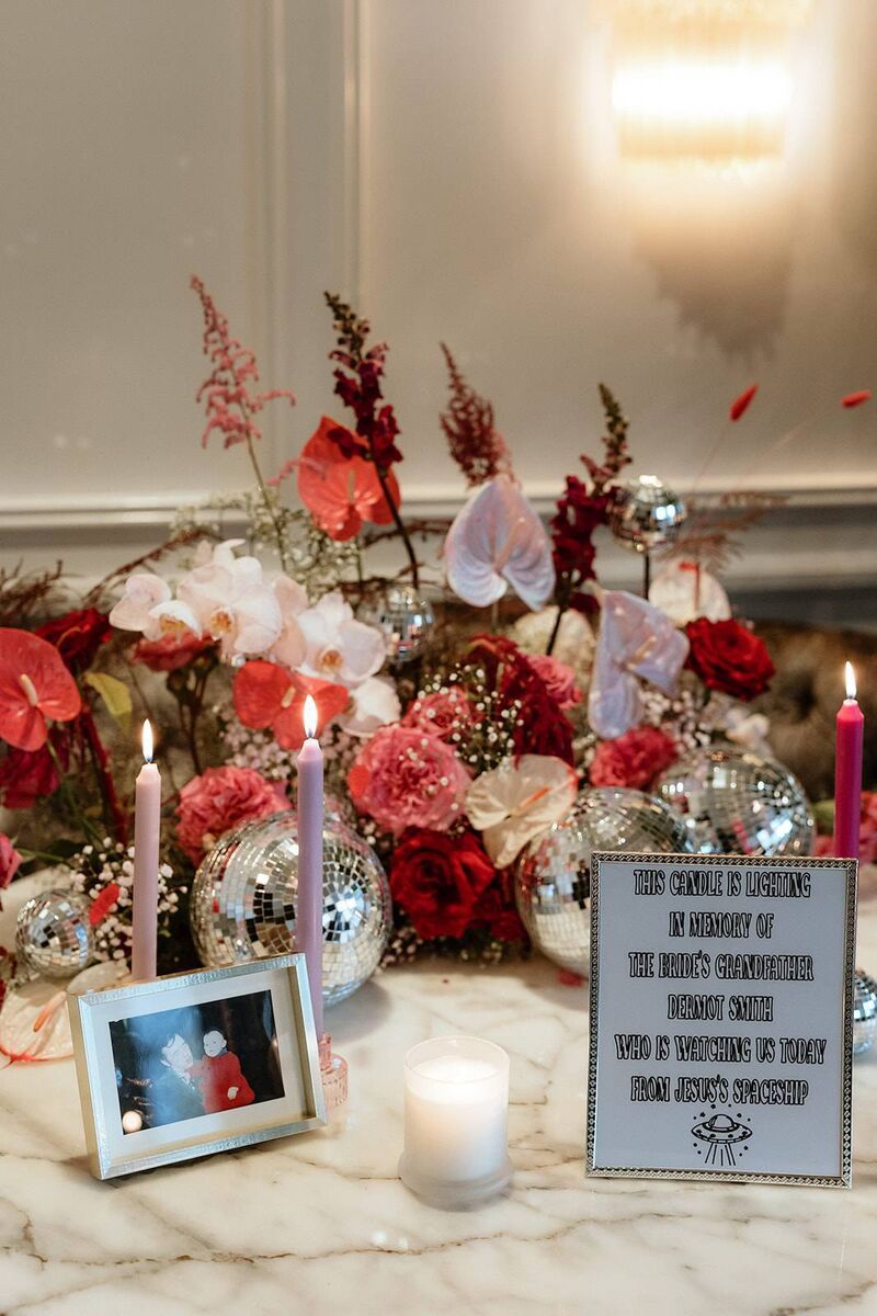 The bride’s grandfather, Dermot Smith, who was very dear to her, was remembered by lighting a candle, with a funny sign. The bride’s grandfather, Dermot Smith, who was very dear to her, was remembered by lighting a candle, with a funny sign.