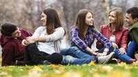 Group of teenage friends having relaxing outdoors