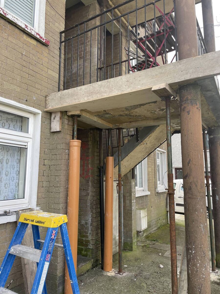A crumbling Fort Street balcony is supported by scaffolding and a timber brace, erected after a previous brace came away a fortnight ago. A crumbling Fort Street balcony is supported by scaffolding and a timber brace, erected after a previous brace came away a fortnight ago.