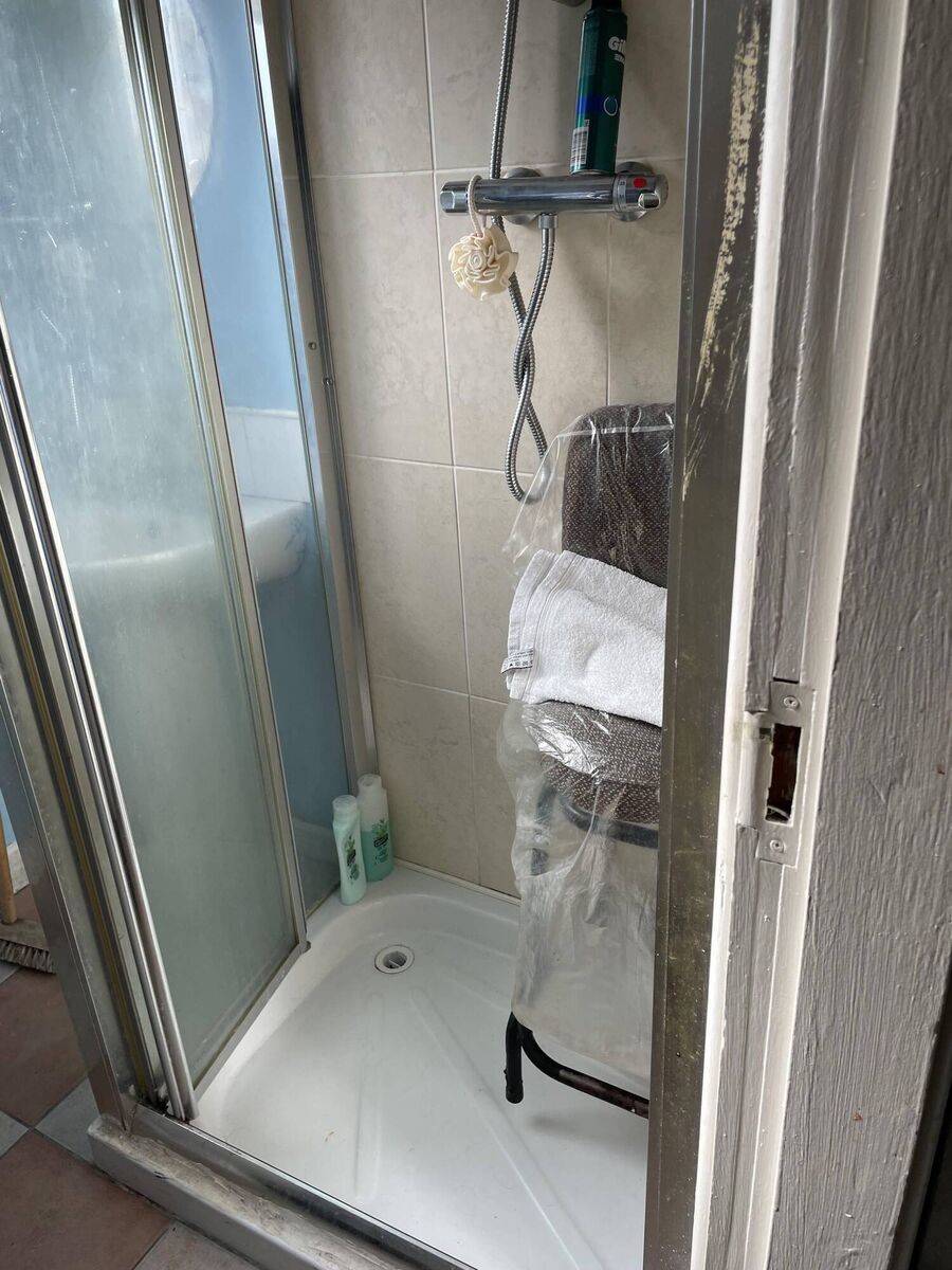 A bar stool, donated by a neighbour, is wrapped in plastic in the shower unit of Fort Street resident "Kayleigh"'s bathroom. Picture: Donal O'Keeffe A bar stool, donated by a neighbour, is wrapped in plastic in the shower unit of Fort Street resident "Kayleigh"'s bathroom. Picture: Donal O'Keeffe