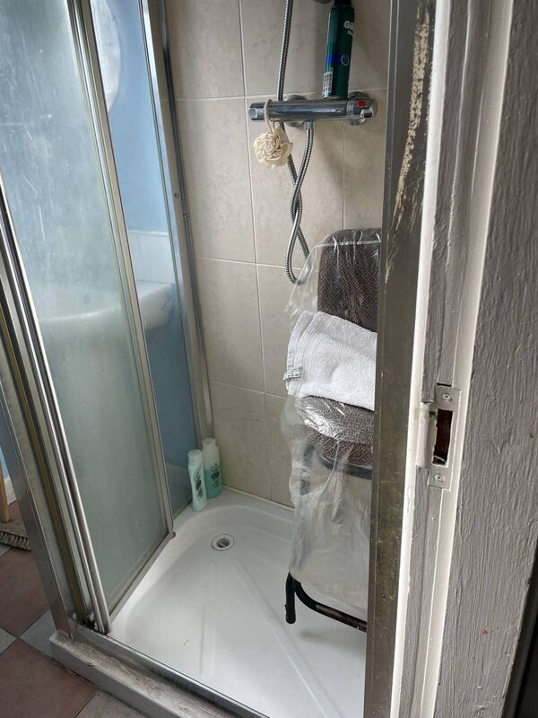 A bar stool, donated by a neighbour, is wrapped in plastic in the shower unit of Fort Street resident "Kayleigh"'s bathroom. Picture: Donal O'Keeffe