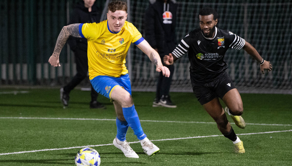 Carrigaline's Andrew Cronin and Alan Munza of College Corinthians chase after a loose ball. Picture: Howard Crowdy Carrigaline's Andrew Cronin and Alan Munza of College Corinthians chase after a loose ball. Picture: Howard Crowdy