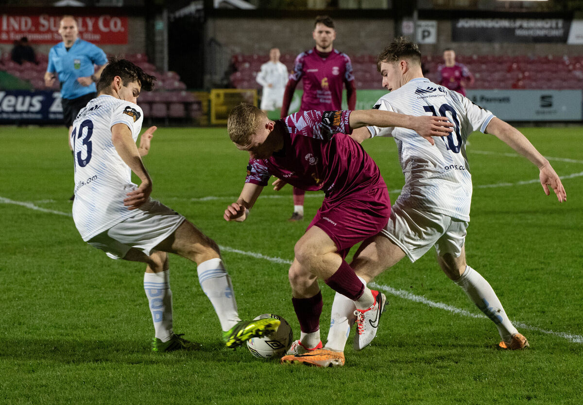 Cobh Ramblers' Cian Browne clashes with UCD players Donal Higgins and Ciaran Behan. Picture: Howard Crowdy
