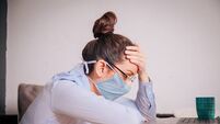 Woman with a mask on her working from home