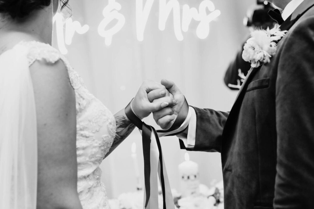During their ceremony, the couple tied the knot using ribbons with the help of their twins, they jumped the broom from the old life to their new, and kissed under the mistletoe. During their ceremony, the couple tied the knot using ribbons with the help of their twins, they jumped the broom from the old life to their new, and kissed under the mistletoe.