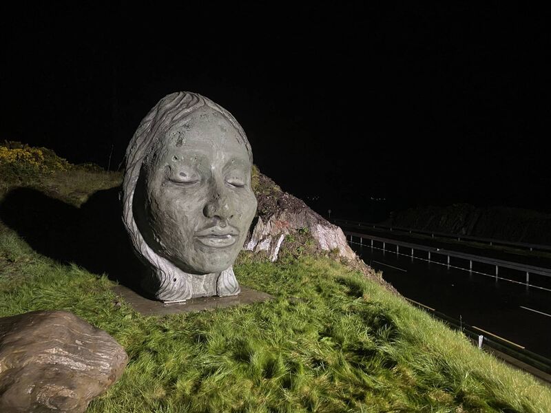 The first ancestral sculpture ‘The Bronze Age Girl’, which can be seen by drivers heading east on the N22 bypass in the townland of Carrigaphooca represents a young female whose remains were found in a burial site during the archaeological works for the N22 development, having been cremated and buried with considerable care and effort at Kilnagurteen some 3,500 years ago. The first ancestral sculpture ‘The Bronze Age Girl’, which can be seen by drivers heading east on the N22 bypass in the townland of Carrigaphooca represents a young female whose remains were found in a burial site during the archaeological works for the N22 development, having been cremated and buried with considerable care and effort at Kilnagurteen some 3,500 years ago.