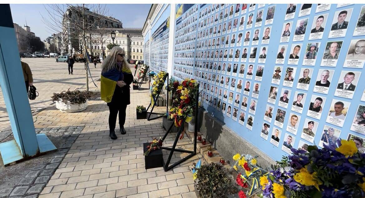 Fiona Corcoran from the Greater Chernobyl Cause paying her respects at the memorial wall in Maidan Square in Kyiv. Picture: Brian Staveley.
