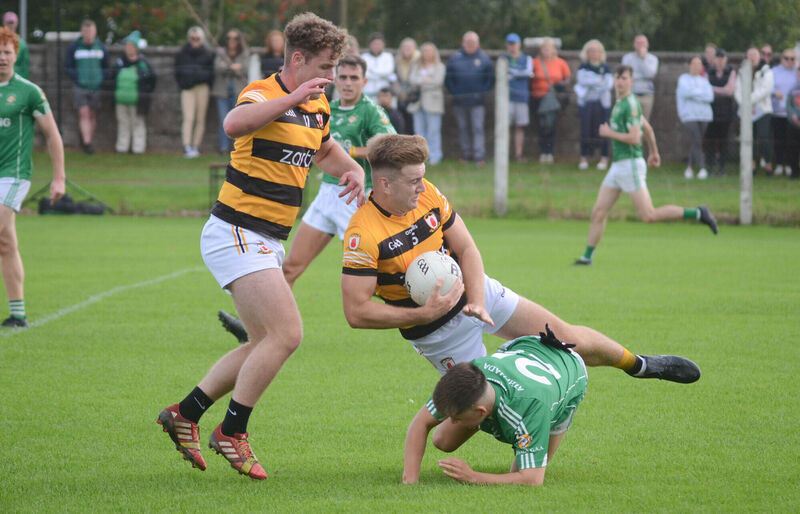 Na Piarsaigh's Greg Healy stumbles over Aghada's Max Aherne during the Bon Secours Premier Intermediate Football Championship match in Cobh. Picture: Howard Crowdy