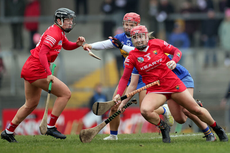 Cork's Libby Coppinger on the ball against Tipperary's Roisin Howard and Caoimhe Perdue during their Very Camogie League Division 1A clash at Páirc Uí Rinn. Picture: INPHO/Laszlo Geczo