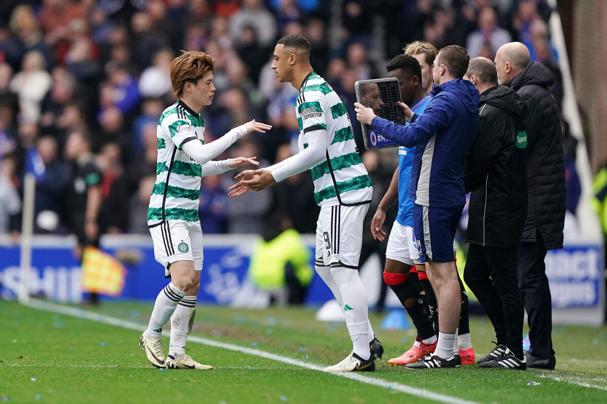 Celtic’s Kyogo Furuhashi (left) is replaced by Adam Idah during the cinch Premiership match at Ibrox Stadium, Glasgow.