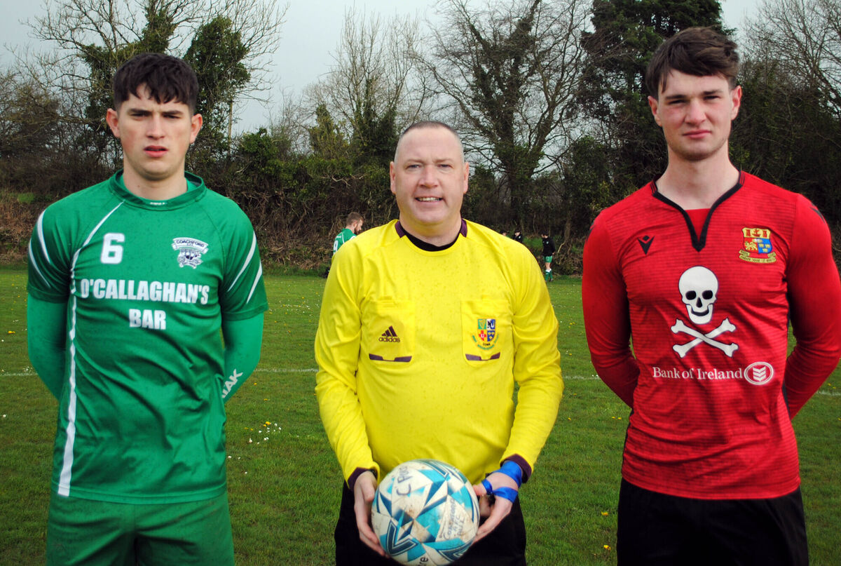 Coachford captain Adam Murphy (left) with UCC's Eoin Heaney, accompanied by referee Alan McDonagh.