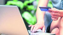 Stylish business woman paying with credit card. Online website identification in laptop. Electronic money transfer. Security fro