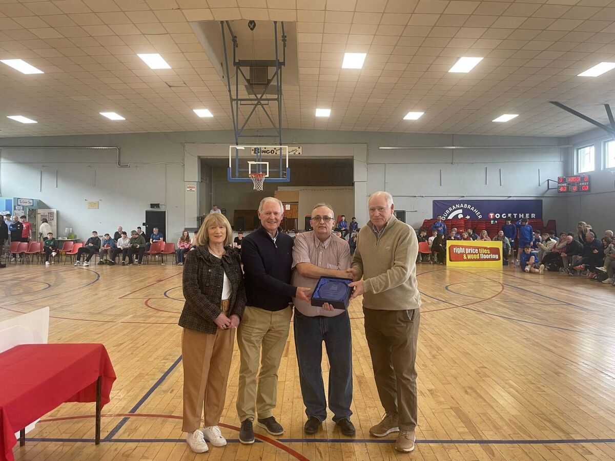  Willie McCarthy, chairman CCBB presents a Hall of Fame award to nephews John and Pat Lucey and niece Rachael Lyons on behalf of the late John Hayes at the GCU Arena.