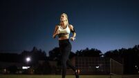 Night shot of athletic woman on running track
