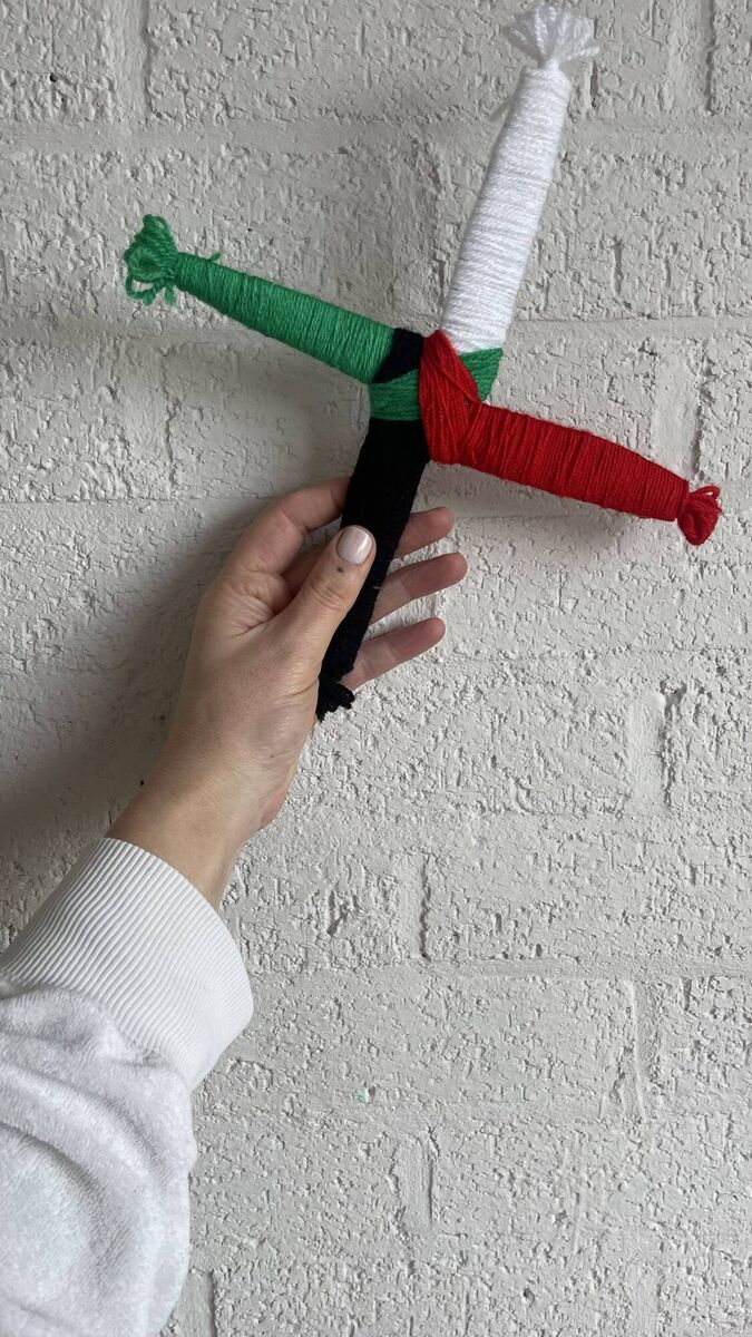 Lilly Higgins holding a Palestine St Brigid's Cross Lilly Higgins holding a Palestine St Brigid's Cross