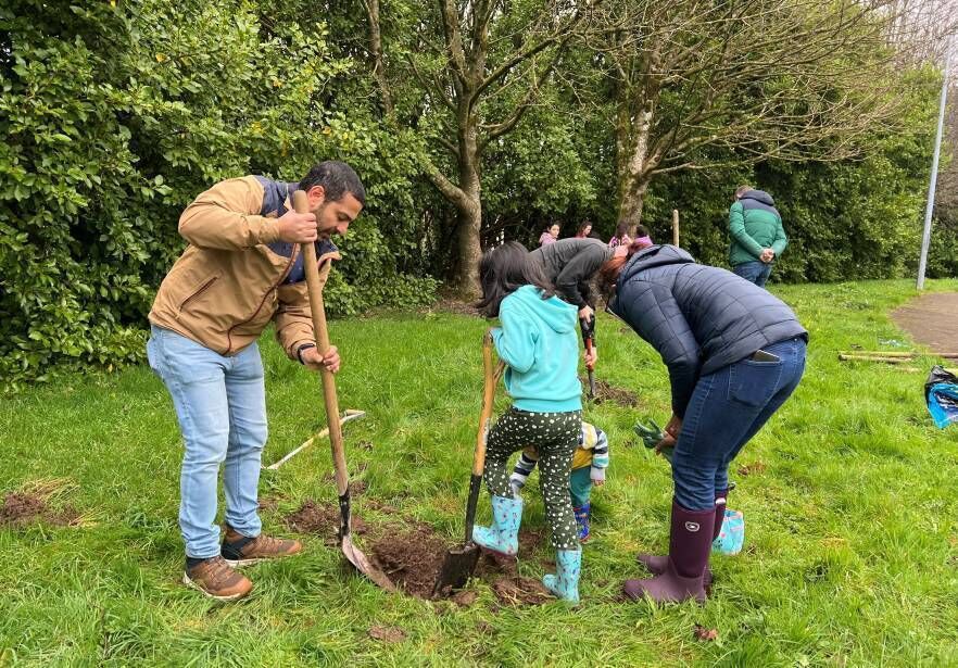 Volunteers planting a mini apple orchard in Bromley Park with local residents. Photo: Douglas Tidy Towns. Volunteers planting a mini apple orchard in Bromley Park with local residents. Photo: Douglas Tidy Towns.