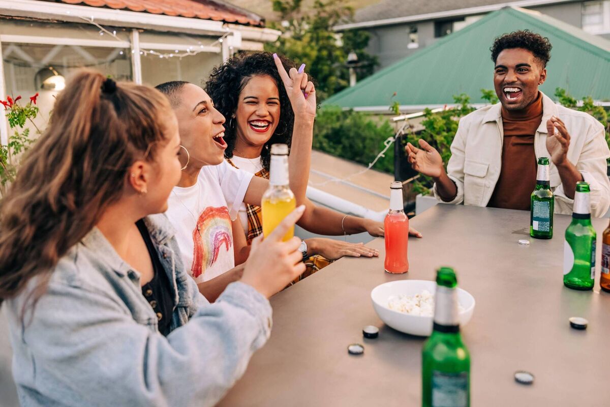 A group of young people enjoying a night out on a rooftop. A group of young people enjoying a night out on a rooftop.