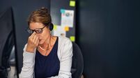 Stressed business woman overworked in office